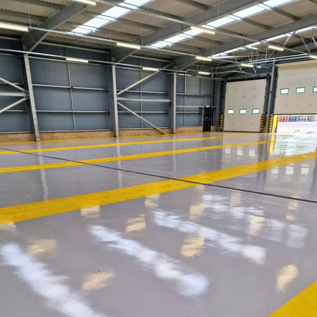 Freshly painted Grey & Yellow floor paint in large warehouse. AndCoat HB Epoxy 