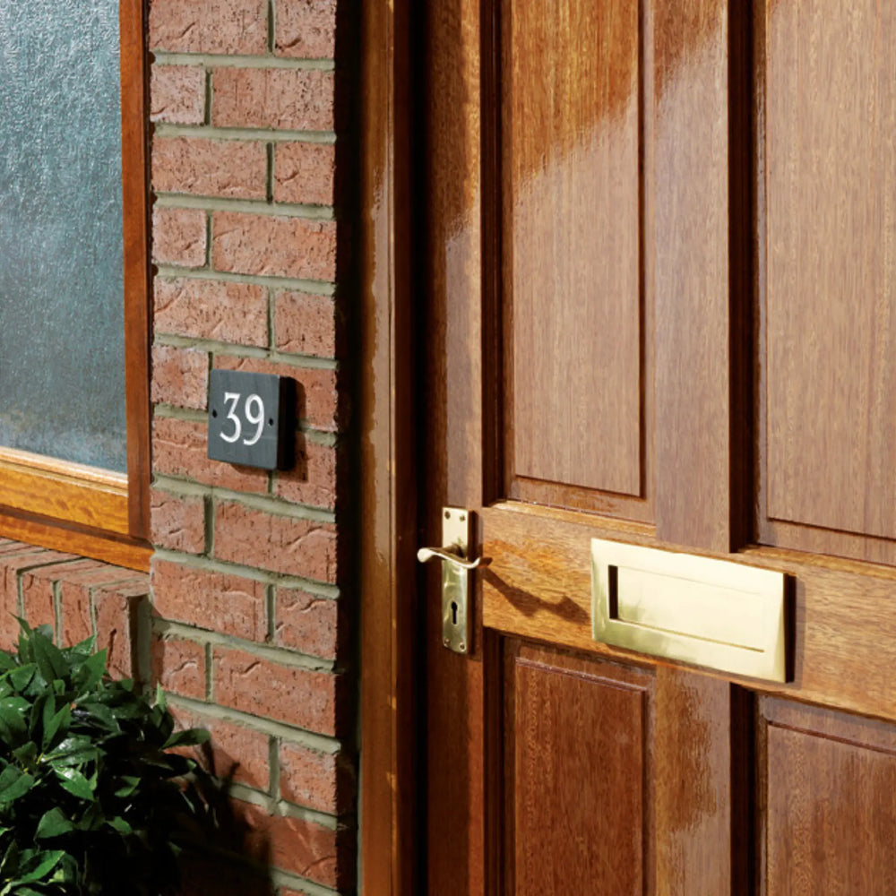 Wooden door with house number 39 on a brick wall