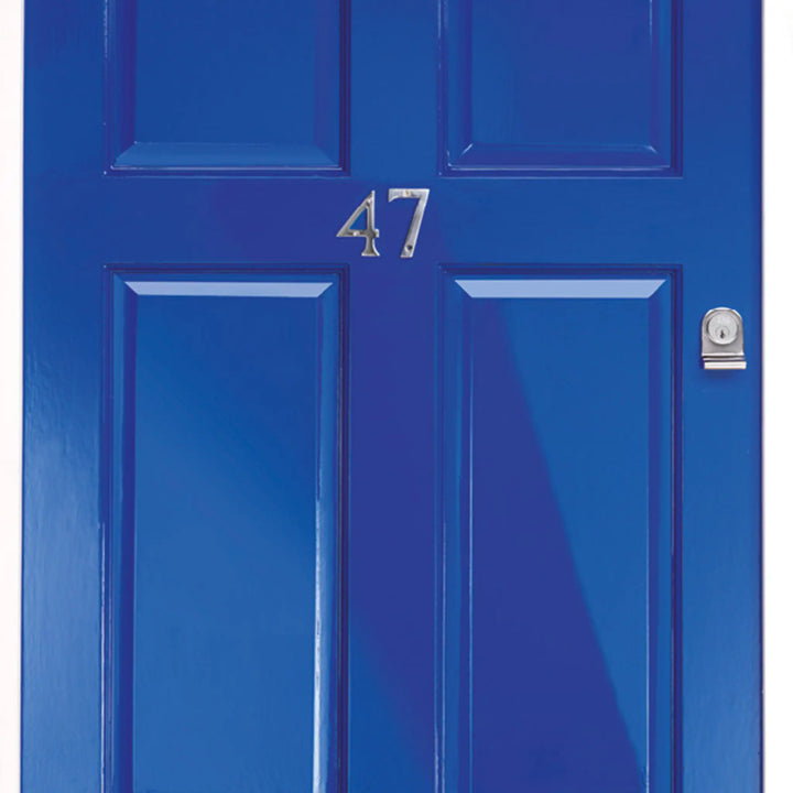 Blue door with the number 47 on a white background