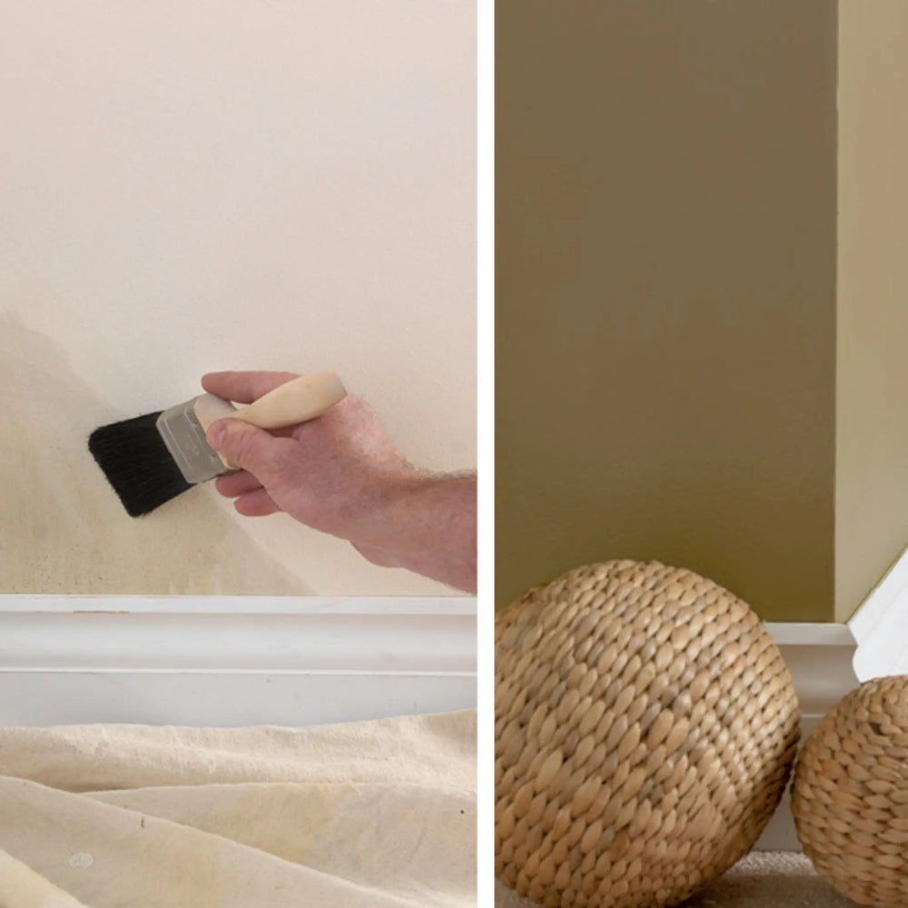Person painting a wall with a brush and two woven balls on the floor.