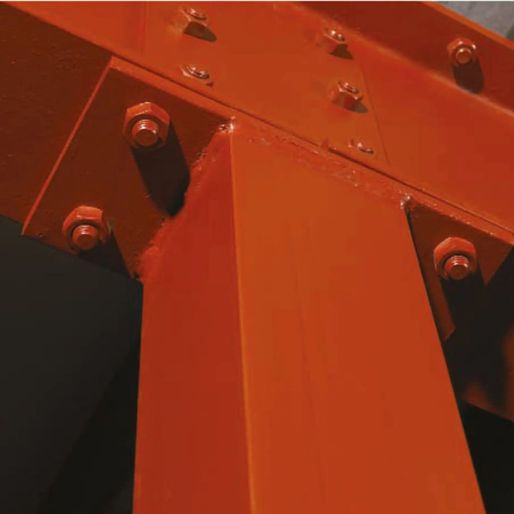 Close-up of a red metal structure with bolts