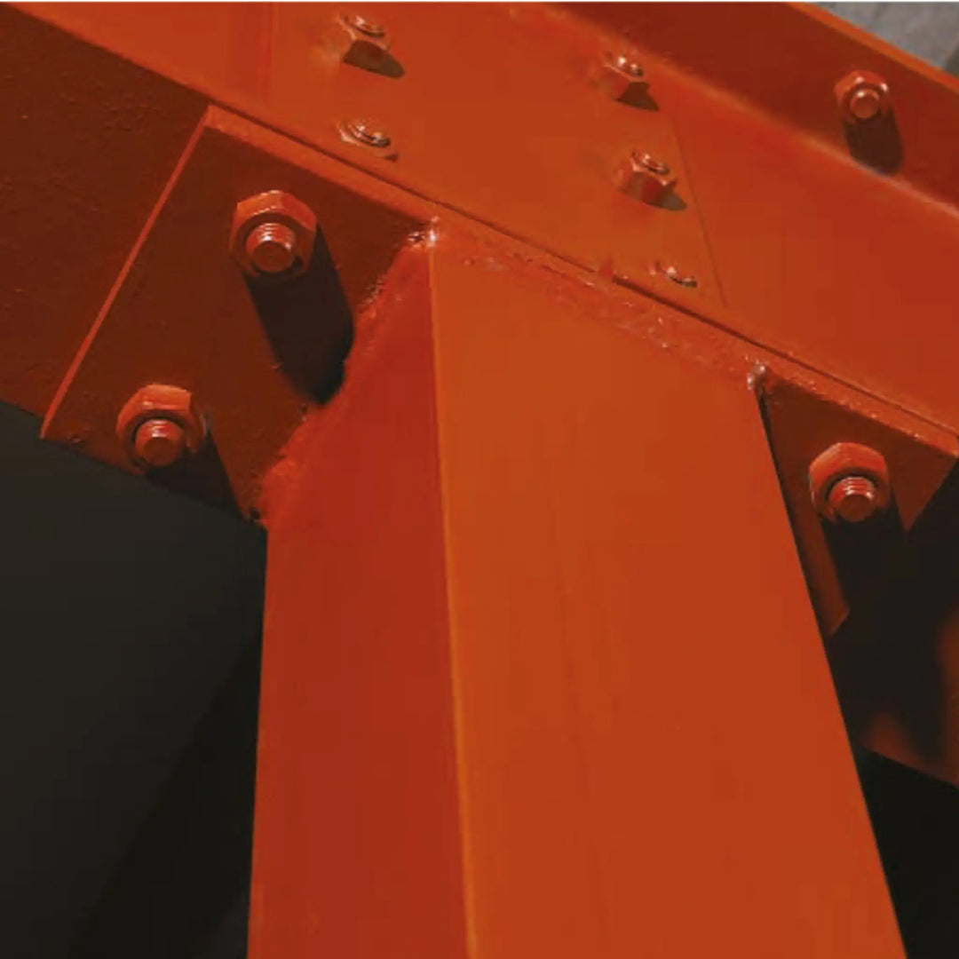 Close-up of a red metal structure with bolts