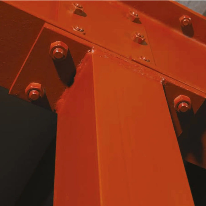 Close-up of a red metal structure with bolts