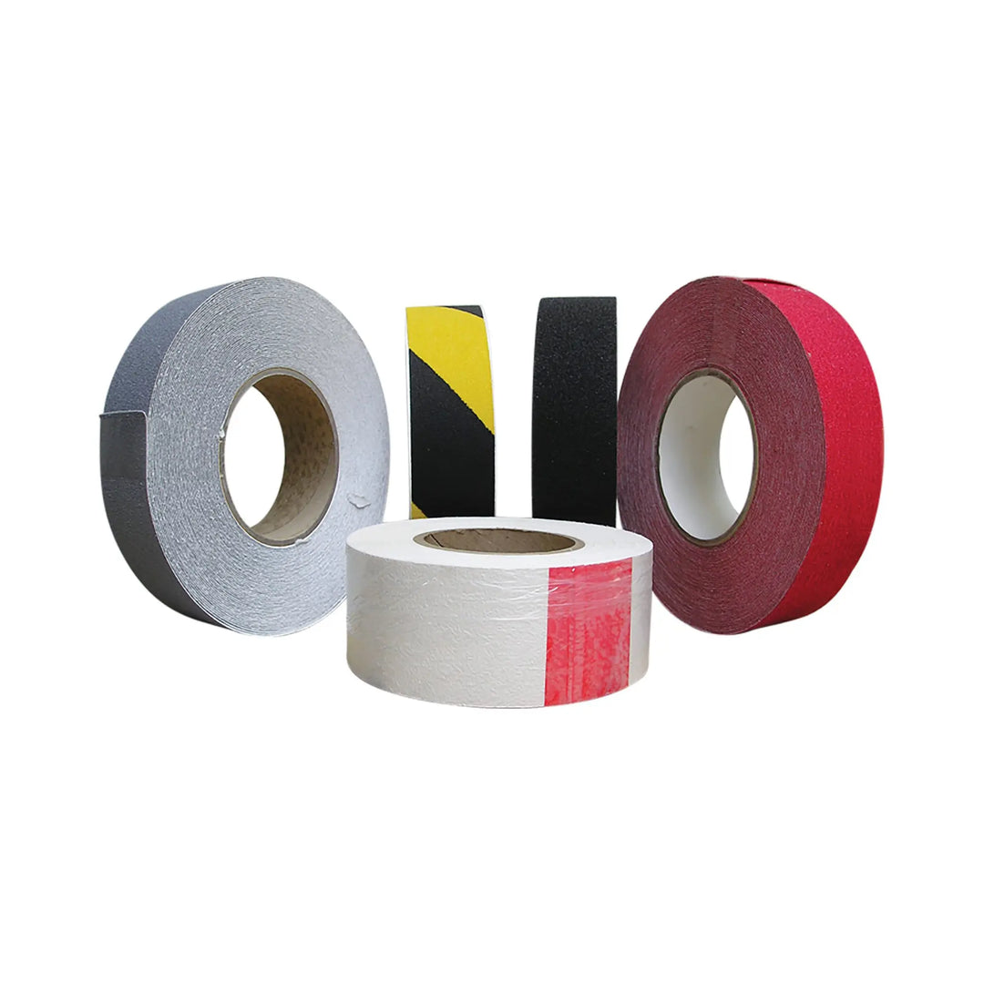 Four rolls of different colored tape on a white background