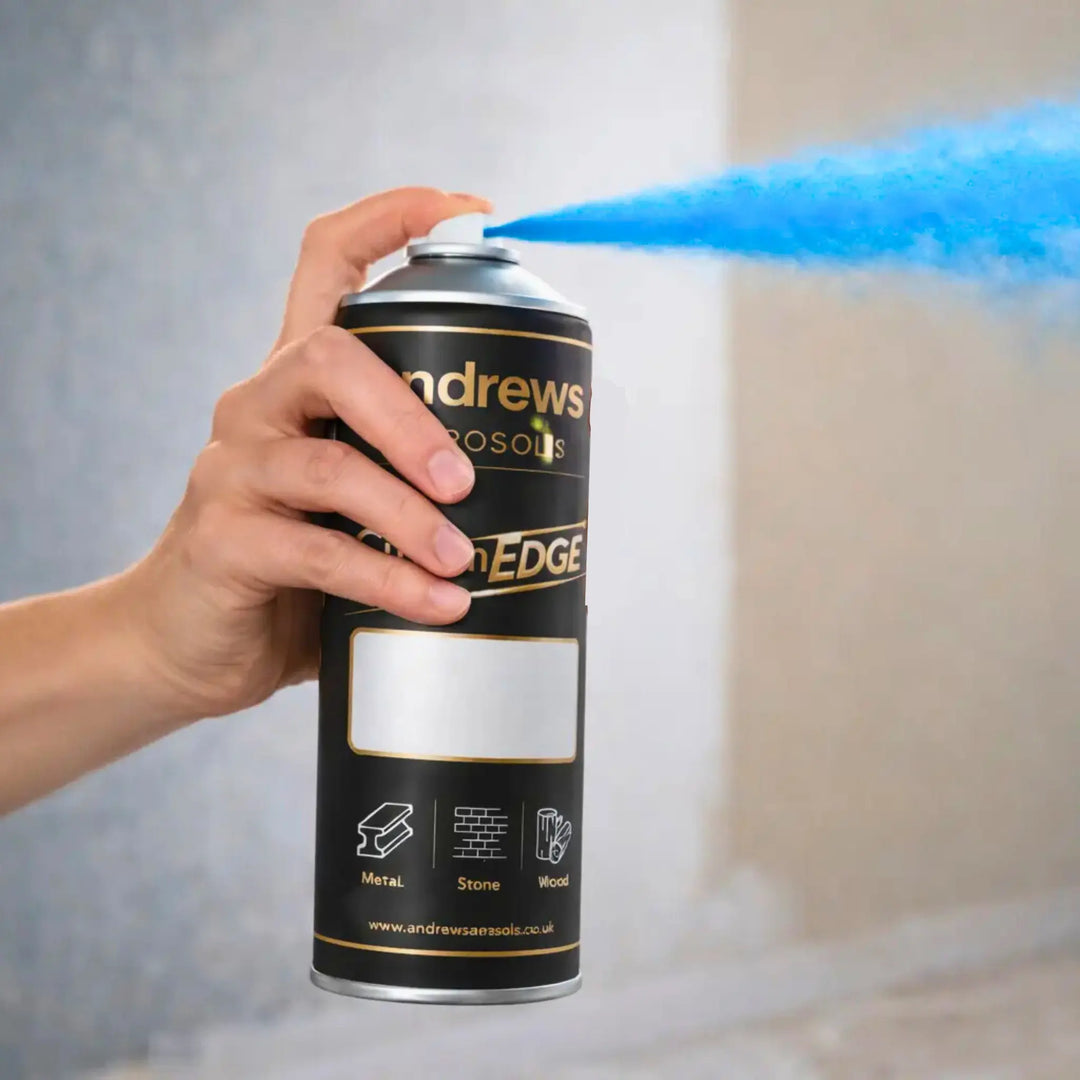 Hand holding a can of Andrews Edge spray paint with blue smoke effect.