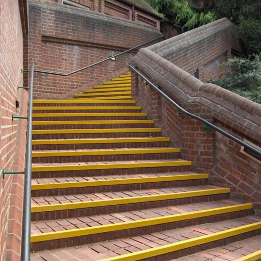 Yellow brick staircase with metal railings on a building exterior