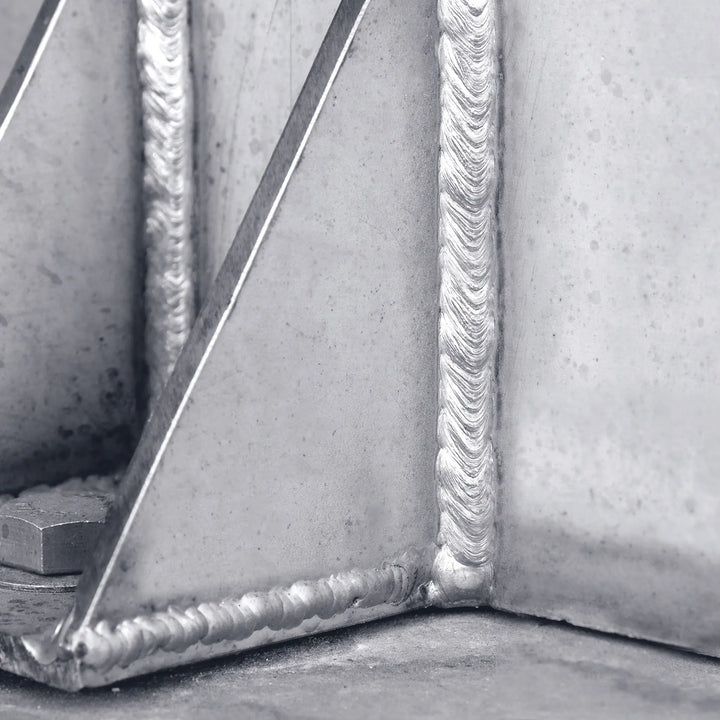 Close-up of a metal weld joint with a beveled edge.