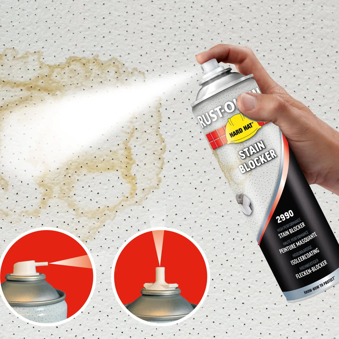 Rust-Oleum Stain Blocker spray can being held above a surface with a stain, showing its use.