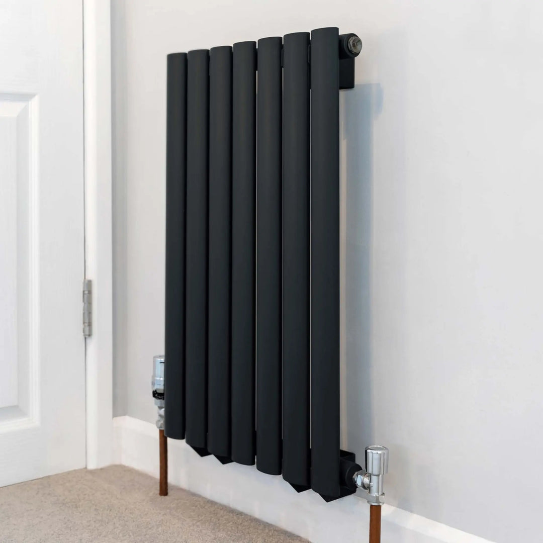 Rust-Oleum Black Matt Radiator Paint - Black Sand on a radiator with a white wall