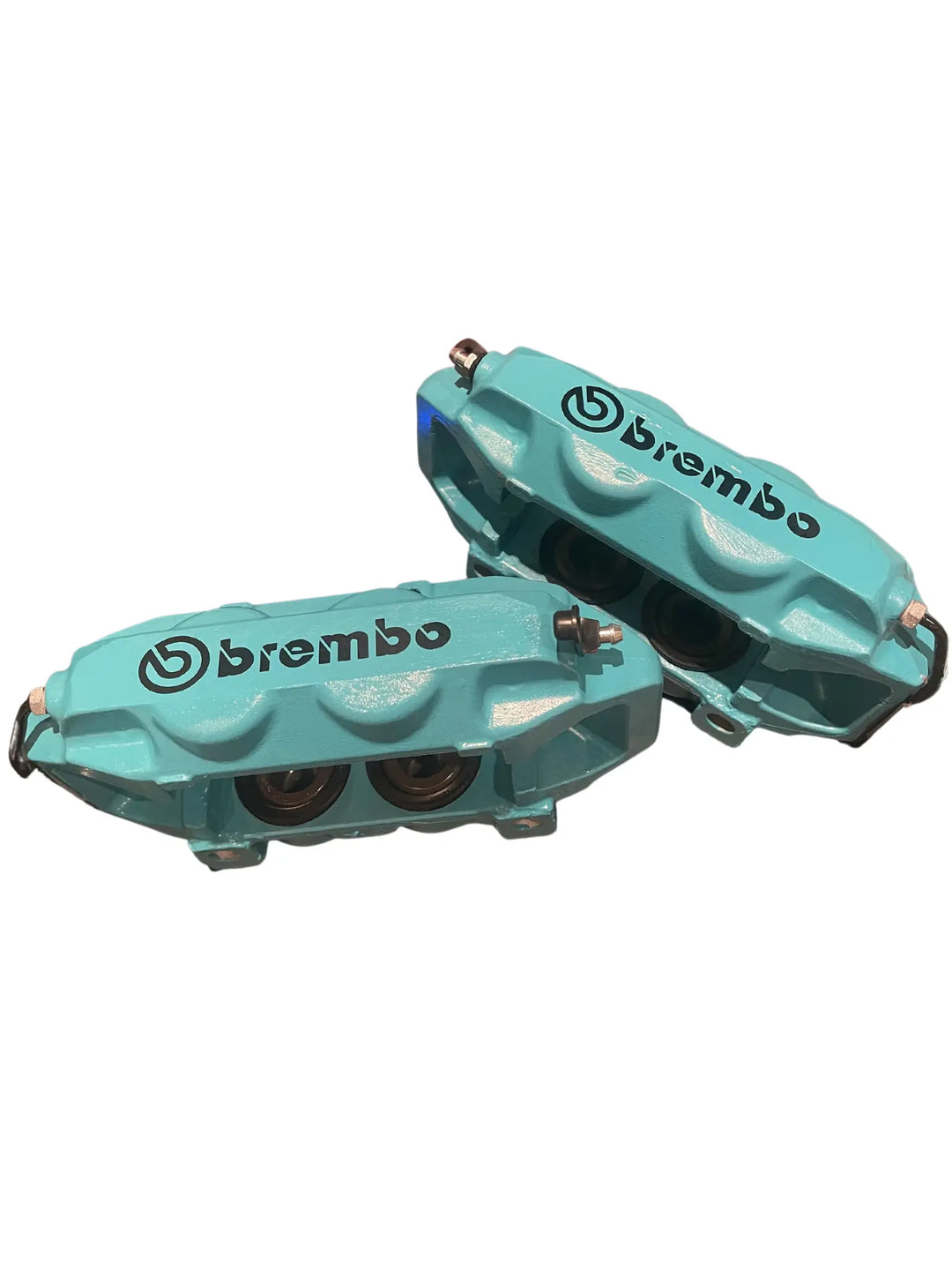 Turquoise Brembo brake calipers on a white background