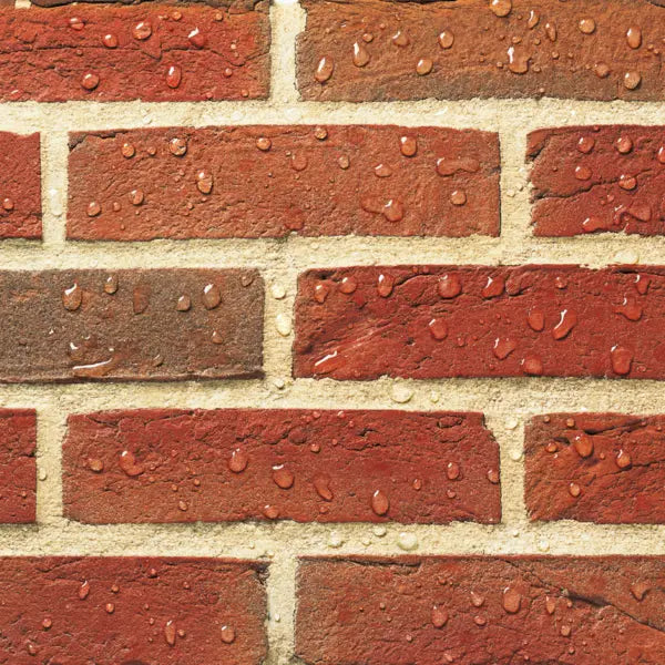 Close-up of a brick wall with red and beige bricks